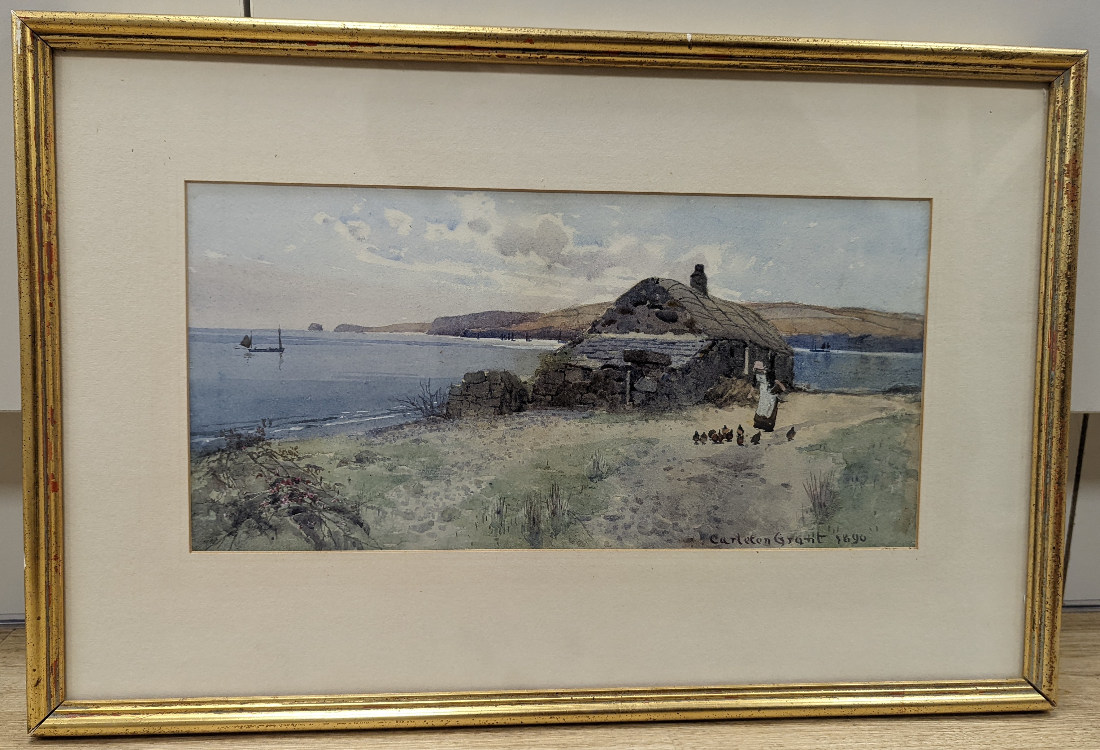 Carleton Grant (1860-1930), watercolour, Coastal scene with woman feeding chickens beside a cottage, signed and dated 1890, 18 x 37cm